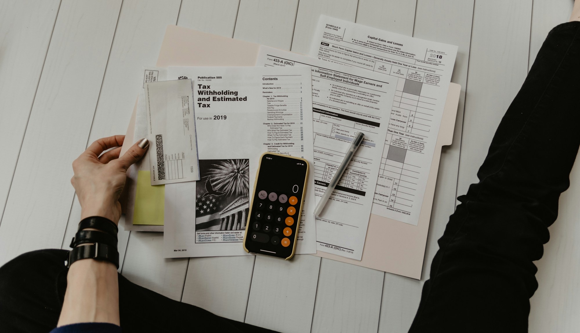 Tax forms, calculator and pen on a desk at the S. Napolitano CPA office